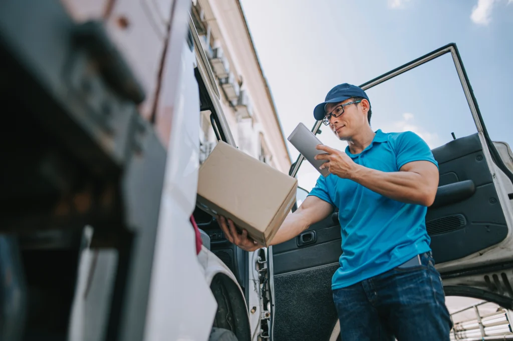 delivery man scanning package barcode